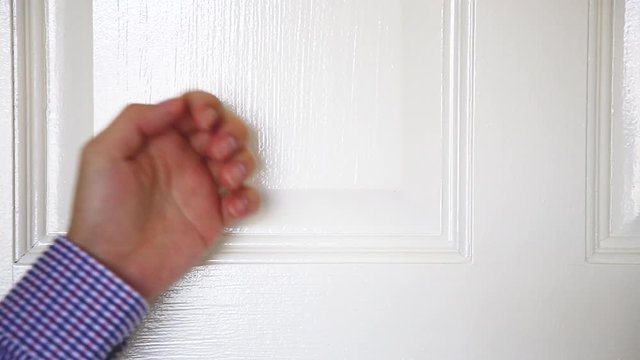 a man man hand knocking the door