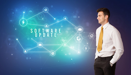 Businessman in front of cloud service icons with SOFTWARE UPDATE inscription, modern technology concept