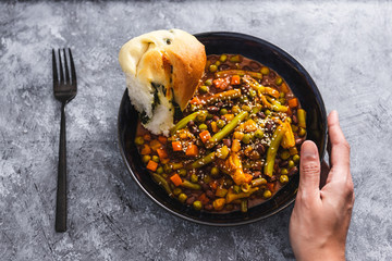 healthy plant-based food, mixed vegetable curry with herbs bread