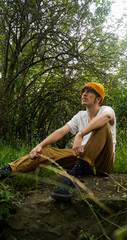  man with mustache and yellow cap looking up at the sky
