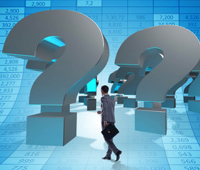 Businessman in uncertainty concept with question marks