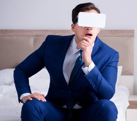Businessman wearing a virtual reality headset in the bedroom