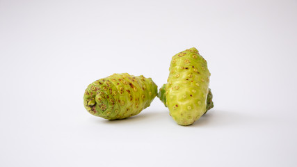 Fresh Noni fruits (Morinda citrifolia) or mengkudu, isolated on white background.