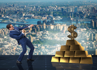 Businessman pulling dollar and gold bullions