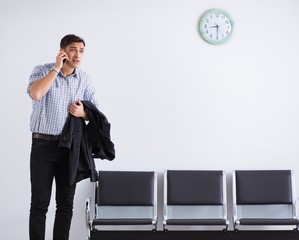 Man nervously impatiently waiting in the lobby