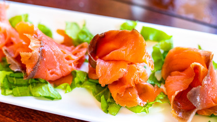 Salted salmon with rosemary, salad and pepper, ready to be served.