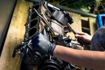 Fototapeta na wymiar Hands working in a car engine. Cleaning a Car engine. Mechanical Workshop
