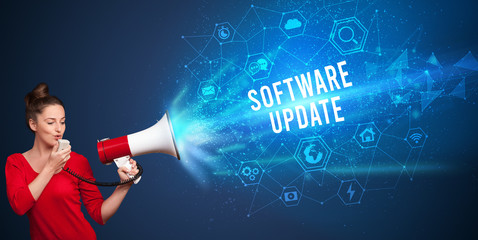 Young woman shouting in megaphone with SOFTWARE UPDATE inscription, Modern technology announcement...