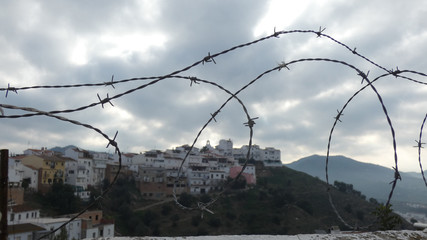View of village church through barbed wire