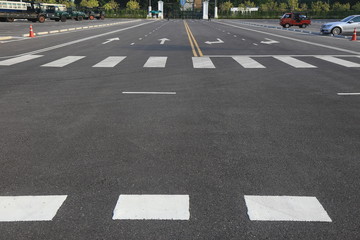 Empty parking stalls in a parking lot, marked with white lines.