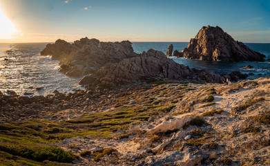Fototapeta na wymiar Sunset on an ocean coast rocky landscape