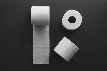 Toilet paper rolls on a black background. Toilet tissue.