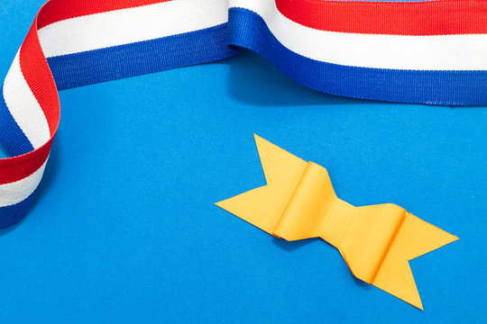 Concept for Kings day in the Netherlands. With an orange bow and a red white and blue ribbon. Room for text. 
