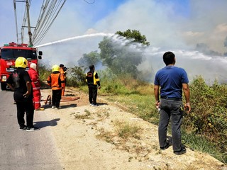Fireman using water and extinguisher to fighting with fire flame in an emergency situation.,There...