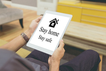 Businessman at home working with tablet,stay at home to reduce risk of infection and spreading the virus.