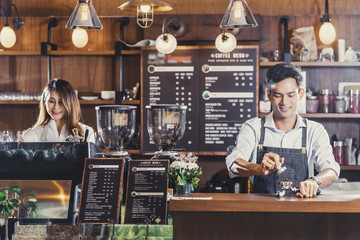 Asian Barista preparing cup of coffee, espresso with latte or cappuccino for customer order in coffee shop,bartender pouring milk,Small business owner and startup in coffee shop and restaurant concept - obrazy, fototapety, plakaty