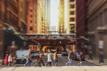Fototapeta na wymiar Blurred Crowd of Chicago street with traffic road intersection in rush hour among modern buildings of Downtown Chicago at Michigan avenue, Illinois, United States, blur business and people concept