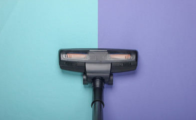 Vacuum cleaner brush on purple blue background. Top view. Cleaning concept.