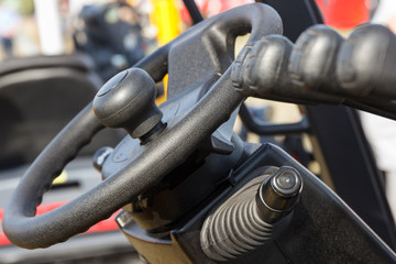 Steering wheel and operating control panels or levers in forklift or other machine