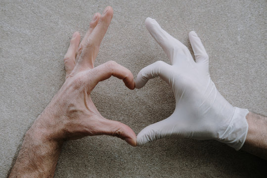 Man hands wearing medical gloves, heart shaped. Health issues, virus protection concept, corona virus, covid 19