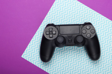 Gamepad on purple blue background. Gaming, leisure and entertainment concept. Top view