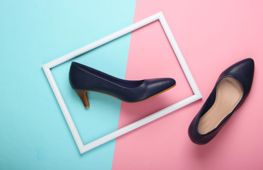 Women's classic high-heeled shoes on blue-pink pastel background with a white frame. Fashion shot....