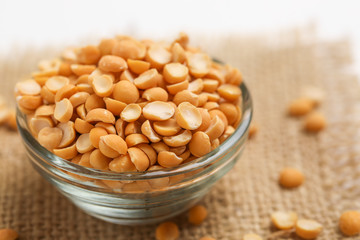 Dried chickpea lentils in Glass bowl on white background , Split Chickpea Also Know as Chana Dal
