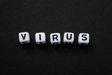 Virus as a text with letters, corona virus pandemic with word cubes on a black background with space for text, no people, mock up