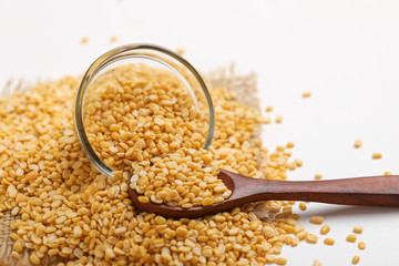 yellow moong mung dal lentil pulse bean in glass bowl on white background