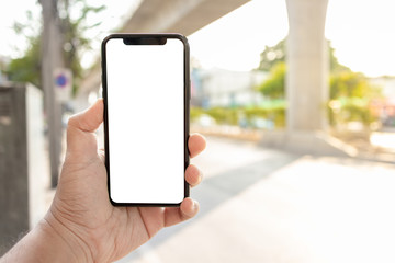 Asian man holding phone mock up left frame at street outdoor have environment train background  isolated display for insert screen