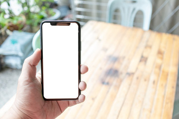 Asian man holding phone mock up left frame at street open application map take to destination isolated display for insert screen