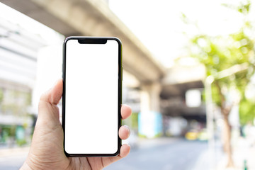 Asian man holding phone mock up left frame at street outdoor have environment train background  isolated display for insert screen