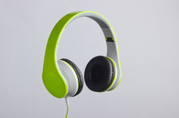 Modern wire stereo headphones on gray background.