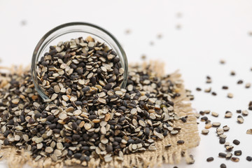 Split Black Lentil Also Know as Black Gram, Black Urad Dal, Vigna Mungo, Urad Beani glass bowl on white background