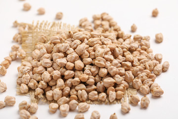 Uncooked dried chickpeas on white background