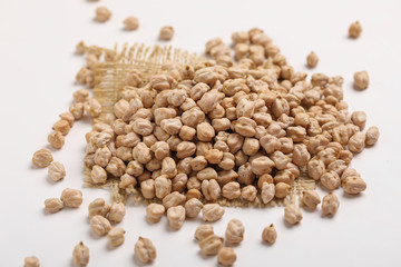 Uncooked dried chickpeas on white background