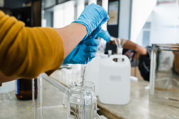 The scientists inject chemicals into plastic tubes,Scientist mix alcohol 75% Hand wash gel Kill the...