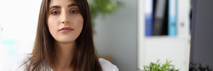 Fototapeta premium Portrait of beautiful businesswoman wearing strict white blouse. Wonderful lady working in international designer company. Business and art design concept. Blurred background