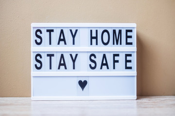 lightbox with text STAY HOME STAY SAFE on table. Coronavirus, Covid-19, Quarantines and Social Distancing concept