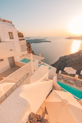 Fototapeta na wymiar White architecture over street and sea view. Tranquil summer travel and vacation. Beautiful sunset on Santorini island, Greece.