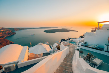 Fototapeta na wymiar White architecture over street and sea view. Tranquil summer travel and vacation. Beautiful sunset on Santorini island, Greece.