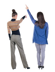 Back view of two pointing girl in sweater.