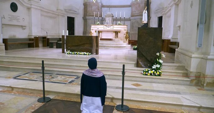 Portuguese religious woman praying to God in church in Lisbon, Portugal, 4K