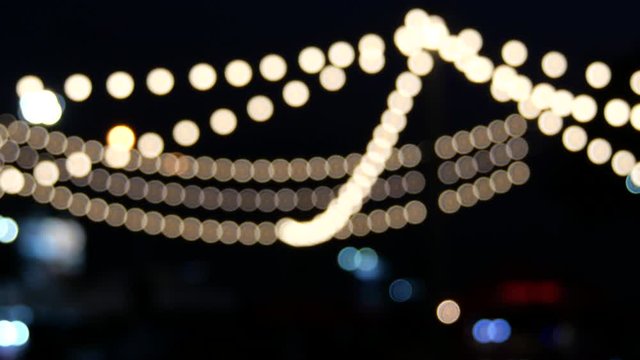 Beautful blurry bokeh of night outdoor festive lightblub.