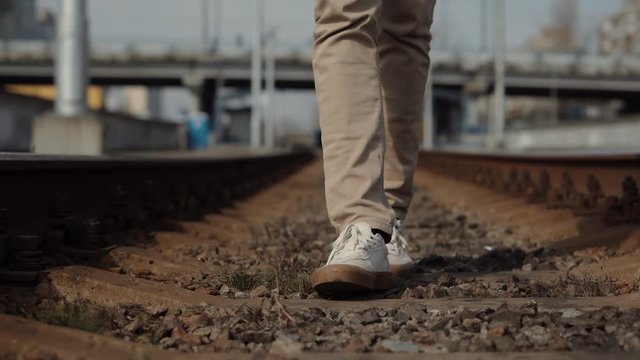 Man Walks To Home On Railroad Tracks After Canceled Public Transport .Tourist Legs Walking On Railway Middle Of Rail.Lonely Businessman Feet In Pants Walking On Rail Road When Train Or Tram Cancelled