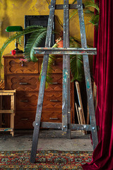 Fototapeta na wymiar old wooden easel in painting studio