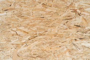 Oriented particle board. Wood background. Background from shavings. OSB for construction work.