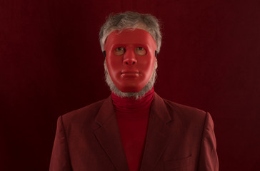 portrait of a man in red clothes and a red mask