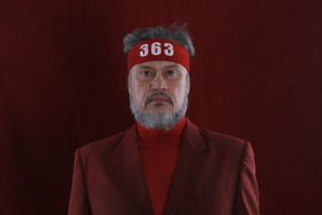 Studio shot closeup portrait of a bearded man in red