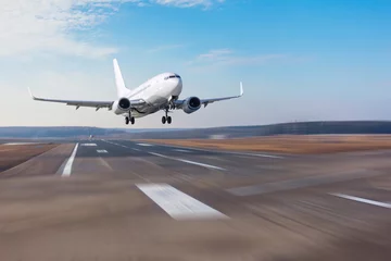 Zelfklevend Fotobehang Runway at the airport and the plane flies and landing. © aapsky